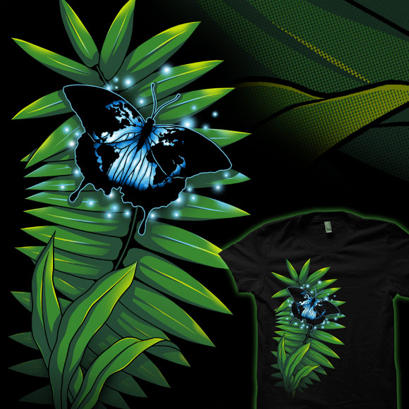 On a black shirt there's a green fern with a blue butterfly that has the pattern of the world on its wings.